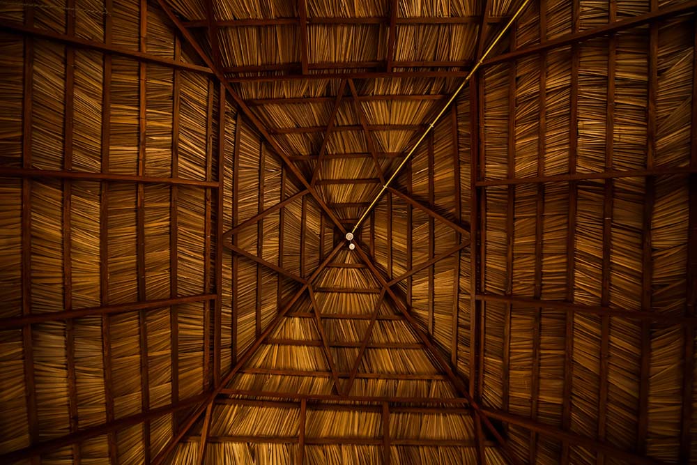 Intricate palmyra-leaf thatched ceiling of a camp tent